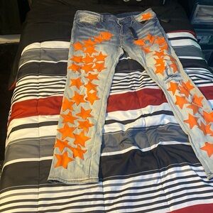 Amiri denim blue jeans with orange stars